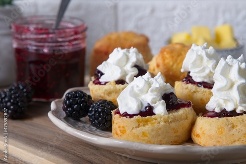 Fresh scones with homemade blackberry jam, cream and fresh blackberries