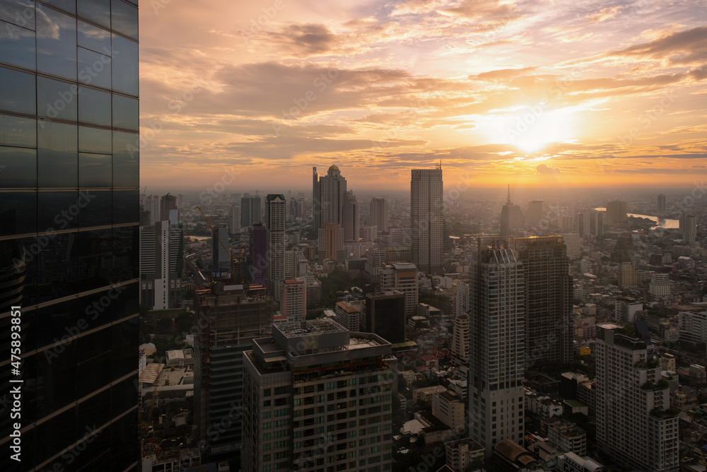 Fototapeta premium Aerial view of Bangkok modern office buildings, condominium, living place in Bangkok city downtown with sunset scenery, Bangkok is the most populated city in Southeast Asia.Bangkok , Thailand