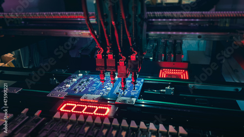 Valokuva Pick and Place robot machine: SMD Assembly of electronic components on a motherboard by an automated Pick and Place robot