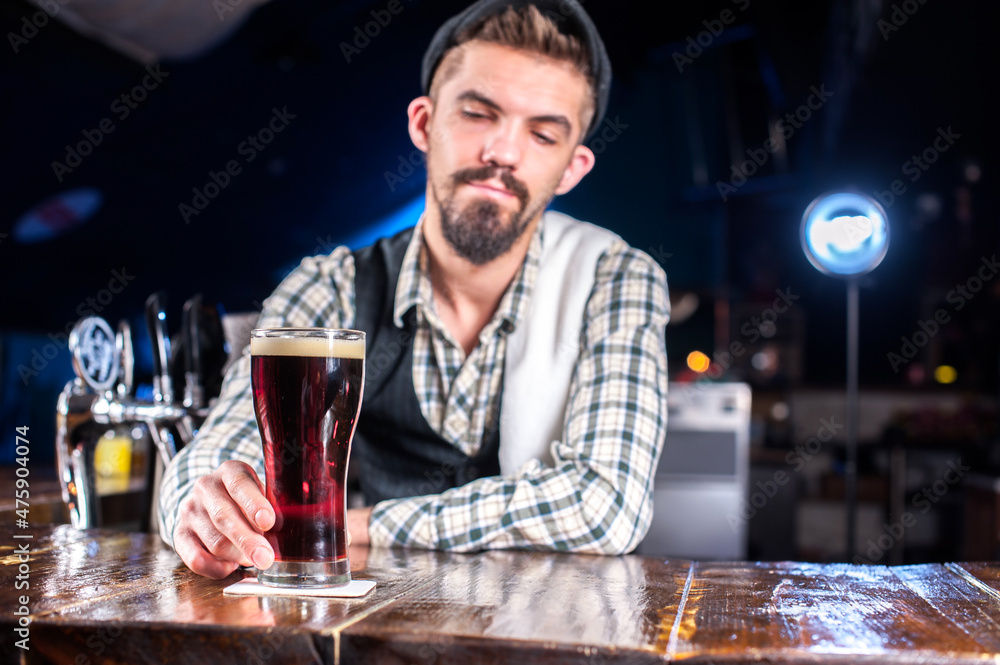 Young bartender demonstrates his professional skills