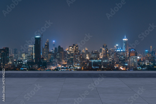 Panoramic Bangkok skyline view, concrete observatory deck on rooftop, night time. Asian corporate and residential lifestyle. Financial city downtown, real estate. Product display mockup empty roof