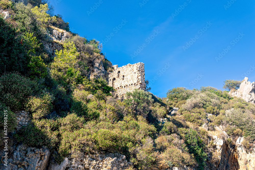 ruins of fortress walls on rocky mountain slopes near the antique city of Olympos, Turkey