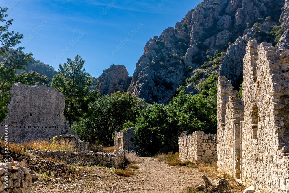 ruins of ancient buildings on the background of mountains in the antique city of Olympos, Turkey