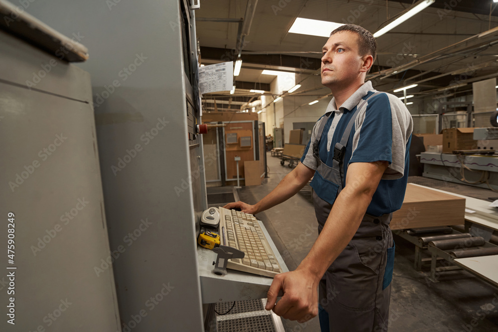Attentive joiner using modern gadget at work