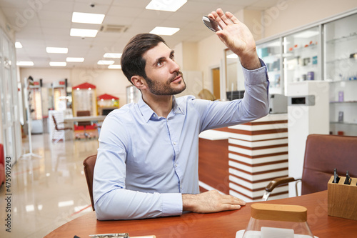 Customer raising photochromic lens and checking it out photo