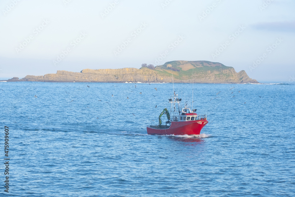 Fishing boat entering Bermeo with the island of Izaro in the background, Euskadi Fishing boat entering Bermeo with the island of Izaro in the background, Euskadi