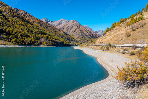 Pontechianale lake during fall season, in the Varaita Valley, Piedmont, northern Italy.