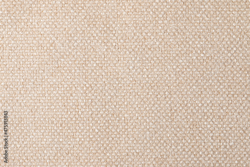 The texture of the fabric. Beige jacquard close-up. Soft expensive fabric for furniture, curtains, pillows and car upholstery. Background. A place to copy.