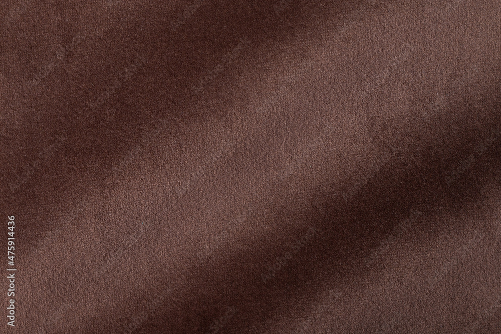 The texture of the fabric. Brown jacquard close-up. Soft expensive fabric for furniture, curtains, pillows and car upholstery. Background. A place to copy. The texture of the fabric. Brown jacquard close-up. Soft expensive fabric for furniture, curtains, pillows and car upholstery. Background. A place to copy.