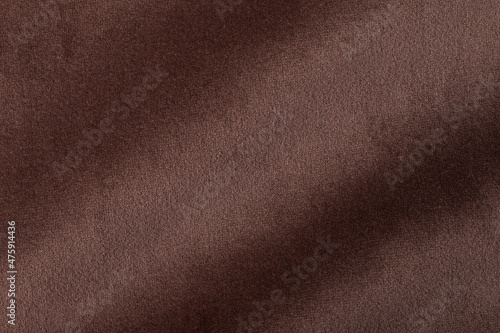 The texture of the fabric. Brown jacquard close-up. Soft expensive fabric for furniture, curtains, pillows and car upholstery. Background. A place to copy.