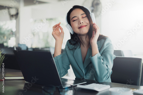 Young beautiful business woman wearing headphone enjoying the music. Relax concept.