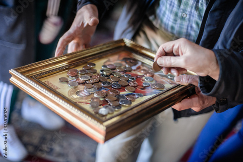 Canvas Believer man collects donations on holy saint icon in church