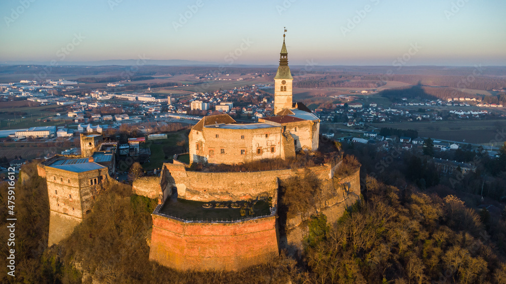 Aerial view of ancient castle Burg Güssing in Burgenland, Austria in a beautiful winter evening sunset mood	
