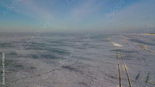 Lake Khanka in the Primorsky Territory in winter. View from above. Frozen coast of a large lake. Arctic landscape. photo