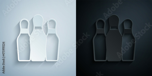 Paper cut Bowling pin icon isolated on grey and black background. Juggling clubs, circus skittles. Paper art style. Vector