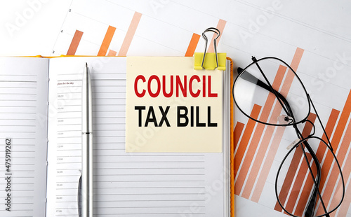 Text CONCIL TAX BILL on sticker on the notepad on diagram background photo