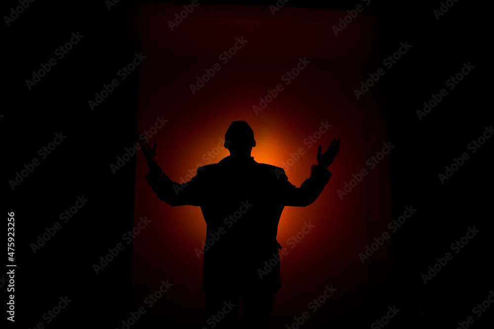 Silhouette man on red background.