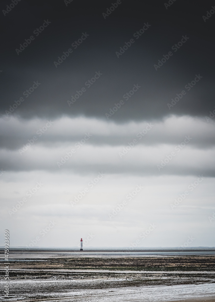 Chauveau lighthouse, isle of Re, at low tide on a stormy day
