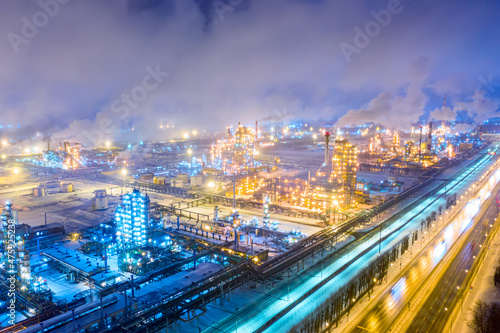 Aerial drone view of petrol industrial zone or oil refinery in Yaroslavl, Russia during winter at night. © Nikolay N. Antonov