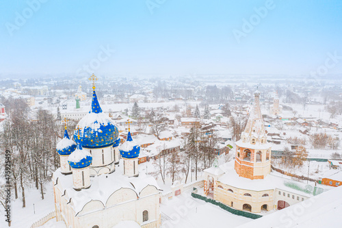 Aerial drone view of Suzdal Kremlin and cathedral of Nativity at the Kamenka river, Russia during winter with snow. Suzdal golden ring of Russia