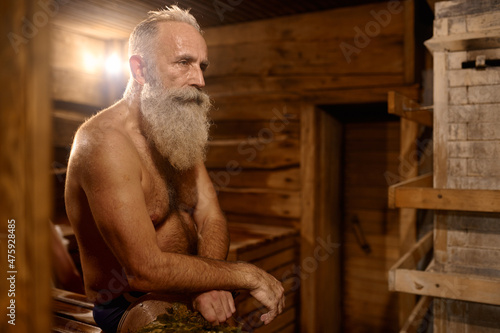 Grey-haired senior man rest at bath house