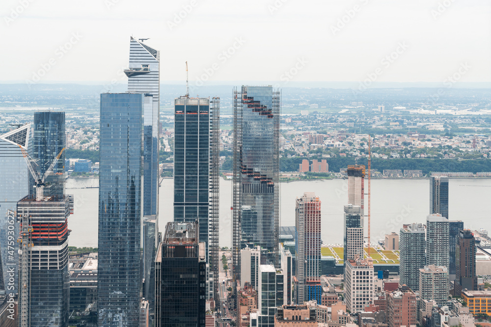 Fototapeta premium Aerial panoramic city view of West Side Manhattan and Hudson Yards district at day time, NYC, USA. New Jersey on horizon over the Hudson River. A vibrant business neighborhoods.