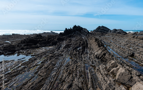 Stone formations on the Aljezur coast in the Algarve, Portugal. Winter time, high tide.