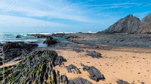 Stone formations on the Aljezur coast in the Algarve, Portugal. Winter time, low tide.