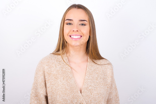 young caucasian girl wearing knitted sweater over white background with a happy and cool smile on face. Lucky person.