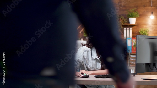 Businesswoman sitting at desk table in startup office typing management strategy using computer keyboard working at marketing project. Entrepreneur woman planning business presentation
