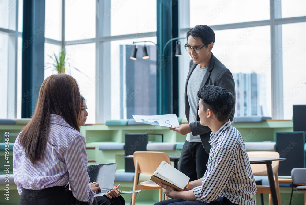A group of Gen Z Asian business consulting, exchanging information in offices, co-working spaces. A group of Gen Z Asian business consulting, exchanging information in offices, co-working spaces.