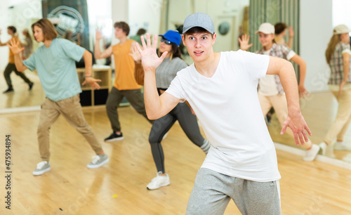 Young boys and girls performing contemporary dance in studio.