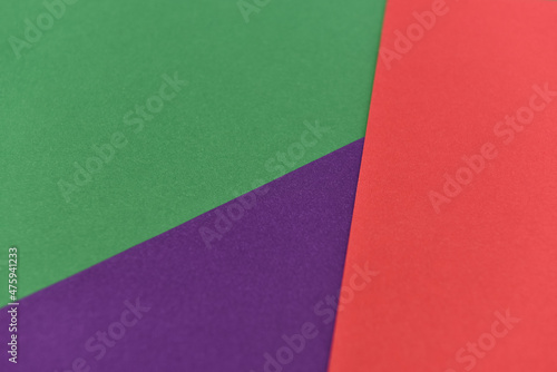 abstract geometric paper background. violet, green and red trendy colors. The backdrop for an invitation card, greeting card or web design. Creative copy space, flat lay