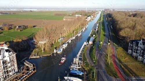 Dutch fishing village Middelharnis on Goeree overflakkee in the Netherlands. The new harbor photographed from the air. Traditional house construction in new neighborhood with traditional architecture.