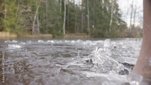 Wallpaper Mural SLOW MOTION - Bare feet smash through the ice to enter the lake for bathing Torontodigital.ca