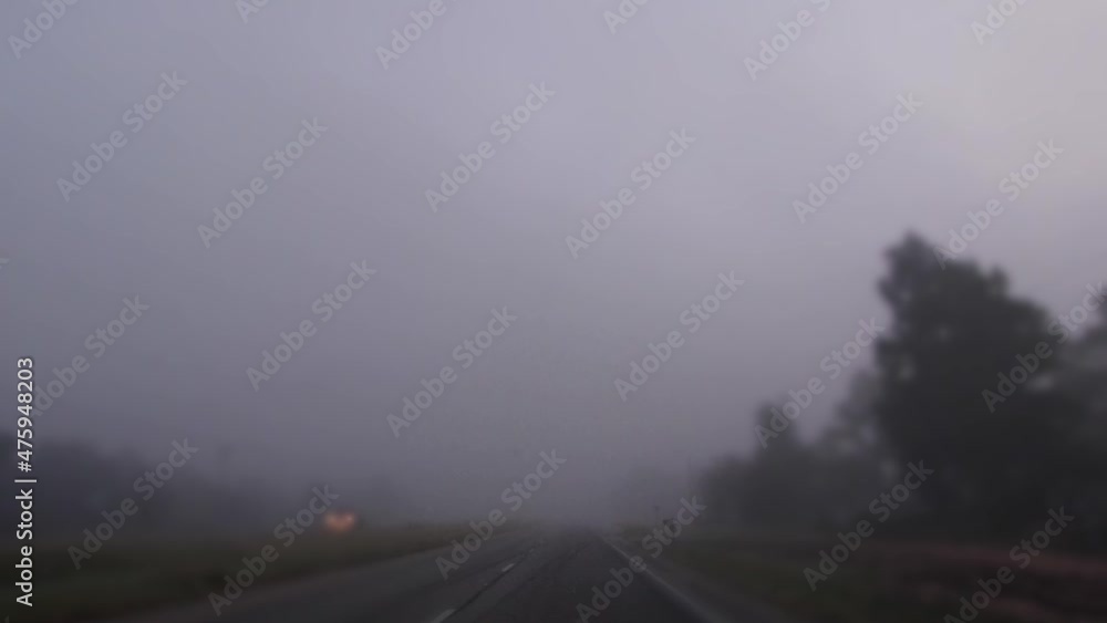 POV driving on a rural highway on a foggy morning in rural Georgia passing headlights POV driving on a rural highway on a foggy morning in rural Georgia passing headlights