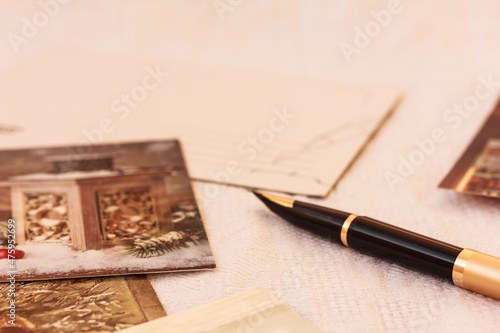 A pen and Christmas greeting cards, blank postcard on white background. Copy space © Anna