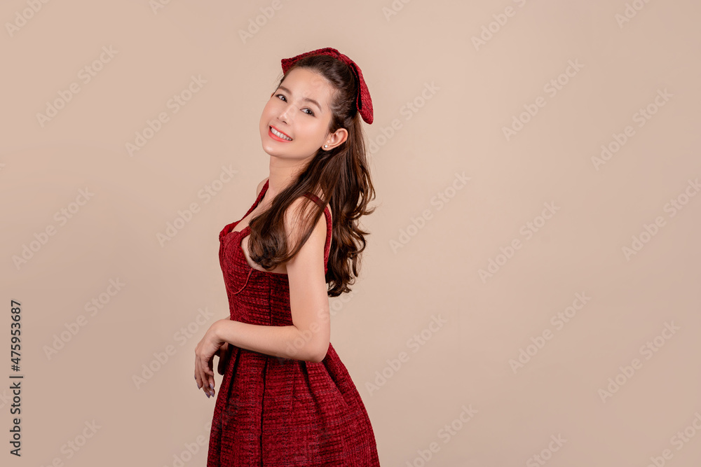 Happy smiling beautiful woman standing in front of the camera on brown background. Happy smiling beautiful woman standing in front of the camera on brown background.