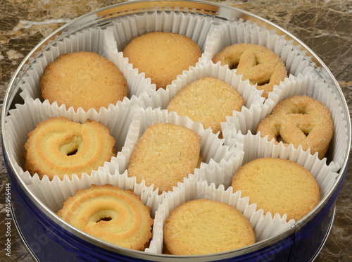 Butter shortbread cookies in paper cups in round cookie tin