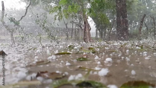 Hail storm with ice solid precipitation falling in the floor, surface low angle view of a natural event outdoor photo