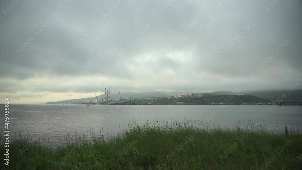 The city of Petropavlovsk-Kamchatsky in the evening on the coast of Avachinskaya Bay, thermal power plant, Sunset The city of Petropavlovsk-Kamchatsky in the evening on the coast of Avachinskaya Bay, thermal power plant, Sunset
