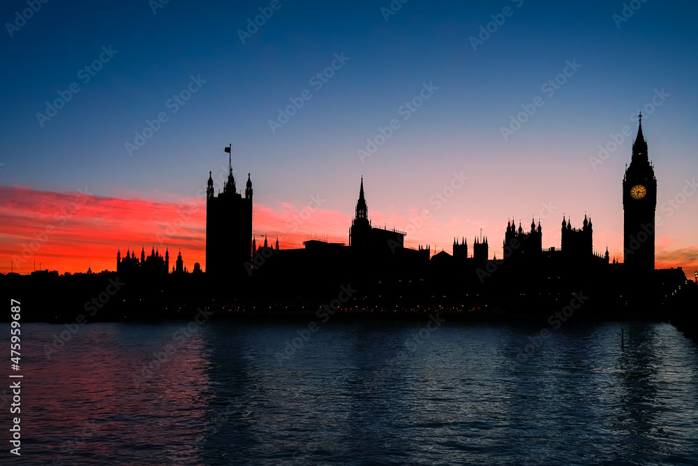 Silhouette of Big Ben and Parliament, London against an orange sunset