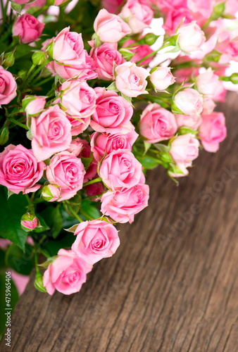 Beautiful Roses Bouquet Flowers on wooden background © Irina Ukrainets
