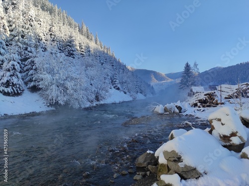 beautiful mountain landscape of carpathians in snow against blue sky. winter in synevyrsky national natural park, tereblya river. ukraine photo