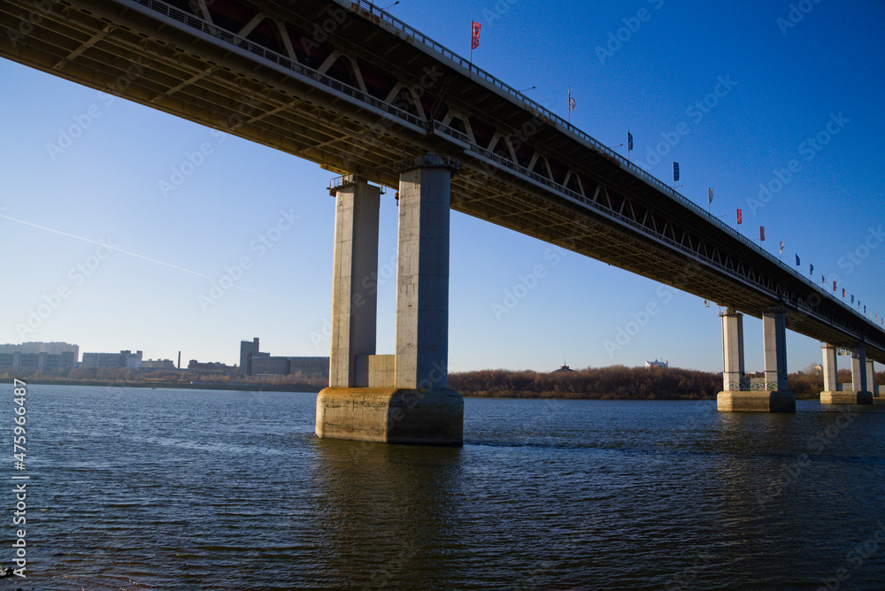 An urban landscape with a bridge over a river. Architecture of urban structures. Bridge construction An urban landscape with a bridge over a river. Architecture of urban structures. Bridge construction