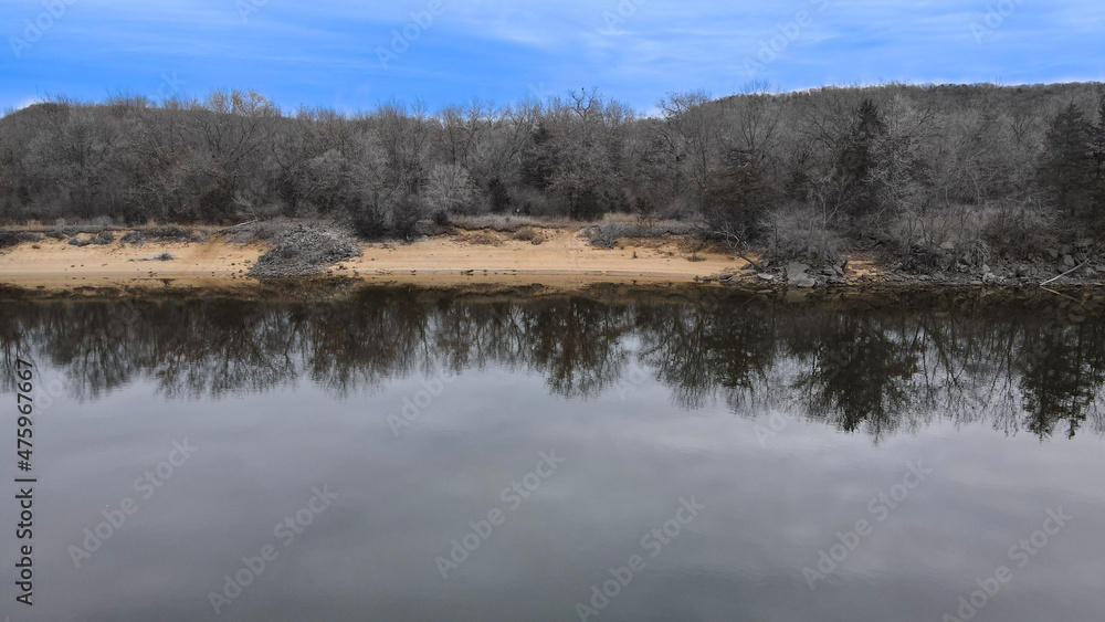 bright blue sky under river with shoreline reflections bright blue sky under river with shoreline reflections