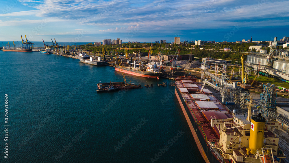 Industrial port in the field of import-export global business logistics and transportation, Loading and unloading container ships, cargo transportation from a bird's eye view.