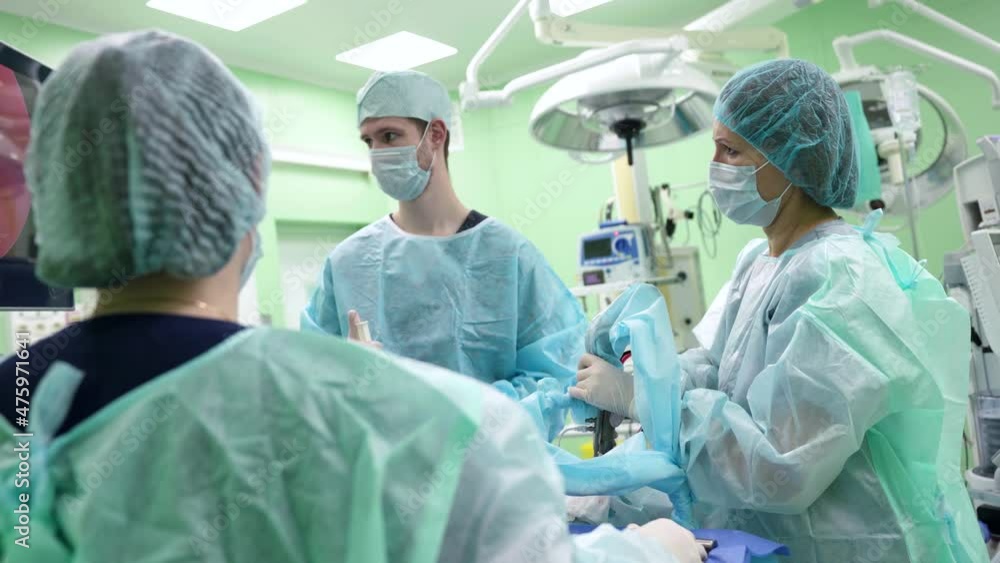 team of highly professional surgeons and nurses is operating patient in modern hospital team of highly professional surgeons and nurses is operating patient in modern hospital