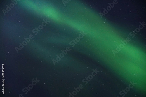 Breathtaking view of Aurora Borealis in the starry sky in Kvaloya, Arctic region in Norway photo