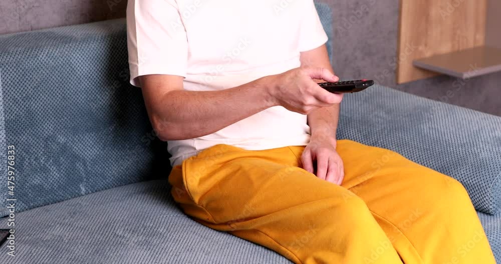 Man's hand selects internet tv channels with remote control. Man's hand selects internet tv channels with remote control.